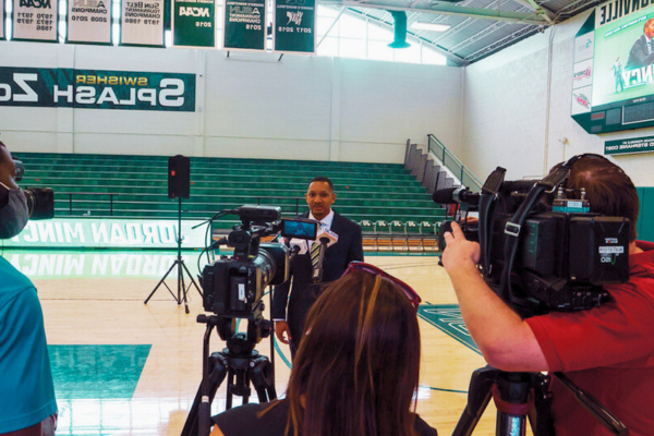 JU Sport Business student being interviewed in the JU gymnasium.